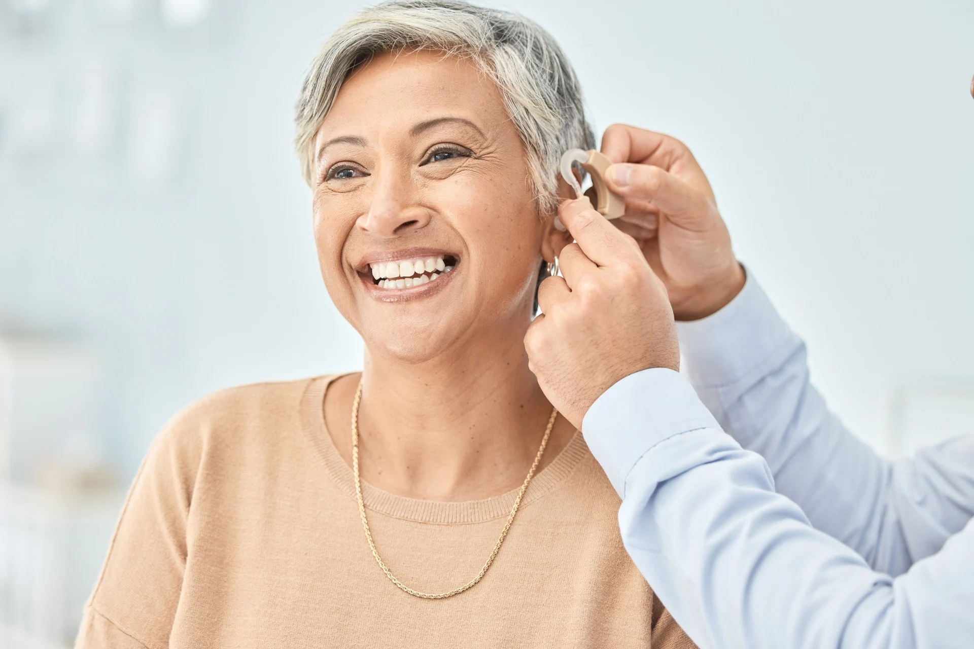 woman getting hearing aid fitted